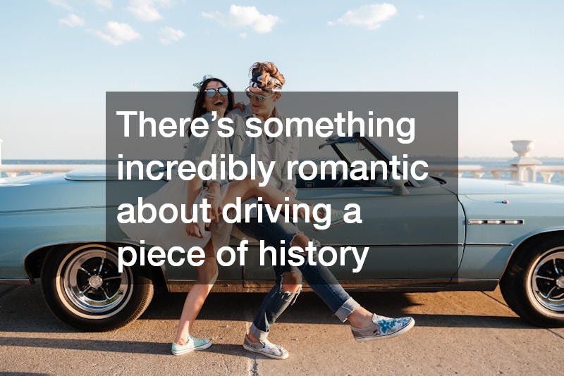 couple posing beside a classic car